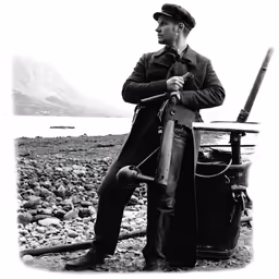 an old time photo of a man with a gun standing in front of his suitcase
