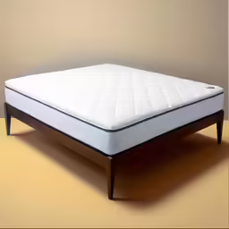 a mattress frame and frame is on the floor