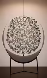 a circular white sculpture on a brown table