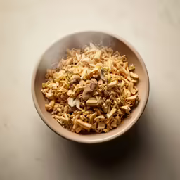 a bowl of pasta mixed with mushrooms and parmesan cheese
