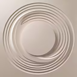the circular sculpture sits in front of white paper