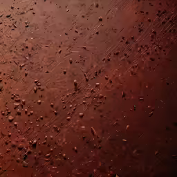 a red background with brown dirt and tiny droplets