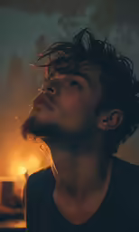 man in dark looking away with smoke behind him