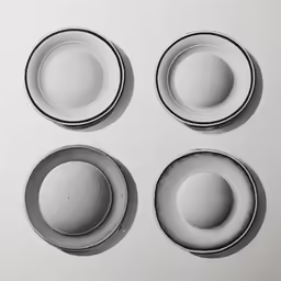 four gray plates on top of each other