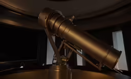 a telescope mounted to the top of a table