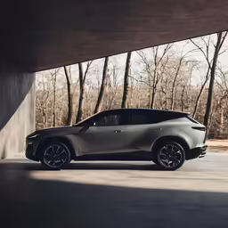 the futuristic vehicle is parked in front of a wall