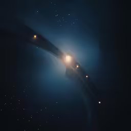 a long car drives underneath a very dark sky