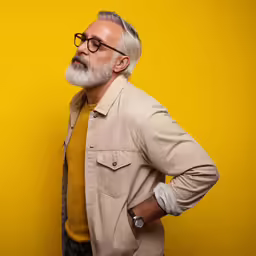 an older man with glasses and a coat
