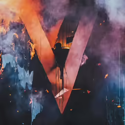 the letter v surrounded by large pieces of smoke