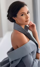 a woman that is sitting down wearing a tie
