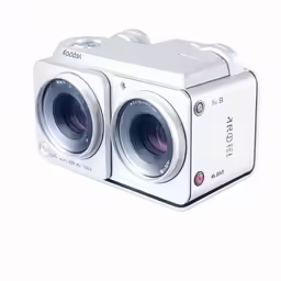 a white camera with two lens and a flash drive