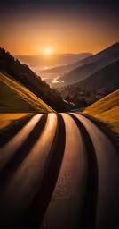 the sun is setting behind the hills above the valley