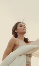 a woman wearing a white shawl is photographed in this close up photo