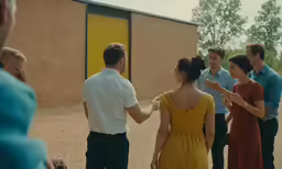 the people are having a conversation near the building