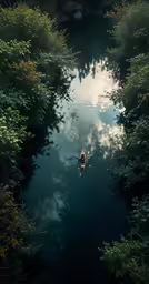 there is a man riding on a canoe on a river