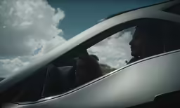 a woman driving in the car and man on the phone