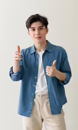 a young man giving thumbs up to his right hand