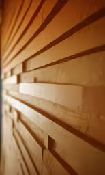 a wooden slat wall with a circular design