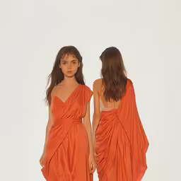 a model wearing a one shoulder orange gown