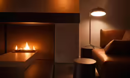 a living room with a fireplace in the corner