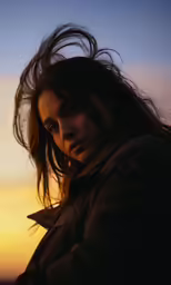 the girl is blowing her hair in the wind