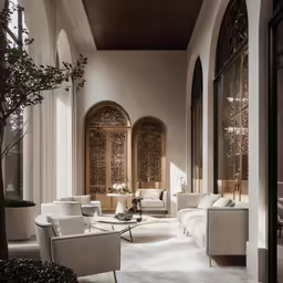 a living room filled with lots of white furniture