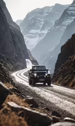 jeep on side of mountain road driving through the mountains