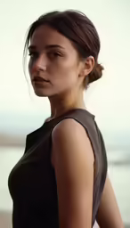 a girl with hair in a bun looks up