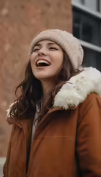 the woman in the jacket is laughing and having fun