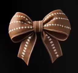 the brown bow is laying on top of the black surface