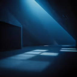 an empty room with several squares at the far end