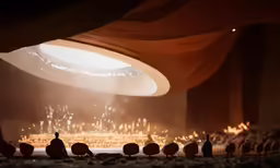 the scene shows three birds near each other, with a drape covering on the ground
