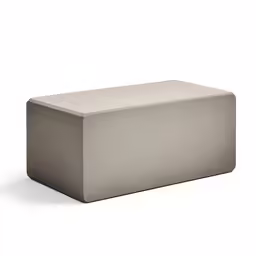 a light grey, modern ottoman sits on the floor