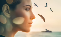 woman profile surrounded by birds flying over her face