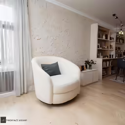 a chair sitting in front of a window on a hard wood floor