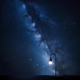 a street light is set on the pavement with the milky in the background