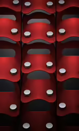 rows of red chairs with holes and holes on them