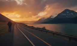 man walks up the middle of a road to a scenic view