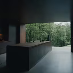 a kitchen counter sitting below an open window