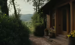 an open door to a small building near some flowers