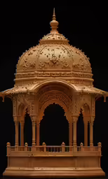 an intricate gold colored carved stone structure in the dark