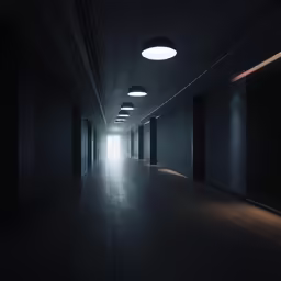 an empty hallway has light at the end