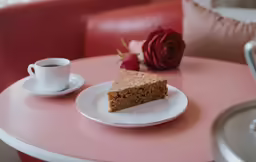 there is a piece of cake and coffee on the table