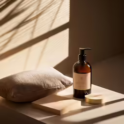 a pillow and shampoo next to a bottle of soap