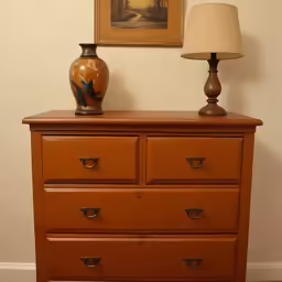two lamps on top of an empty dresser