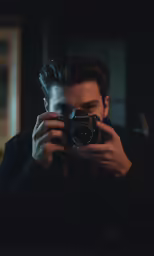 a man holding a camera taking a picture