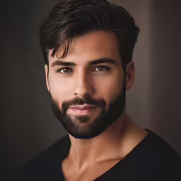 this is a man with a goatee beard posing for a photo