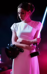a woman in a pink dress holding a flashlight