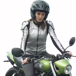 a woman is wearing a helmet while sitting on a green motorcycle
