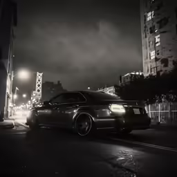 a black and white photo of a car in the city